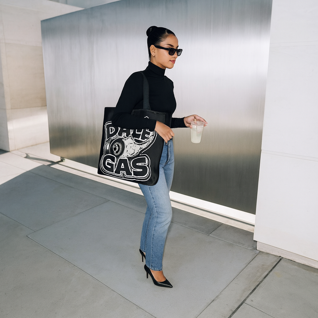 Confident woman modeling Dalè Gas Black Tote Bag against neutral backdrop