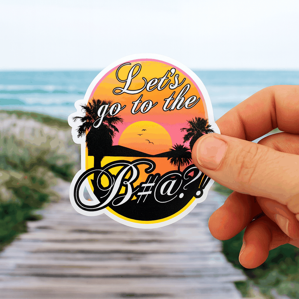 lets go to the bitch sticker held in hand with beach sunset background.