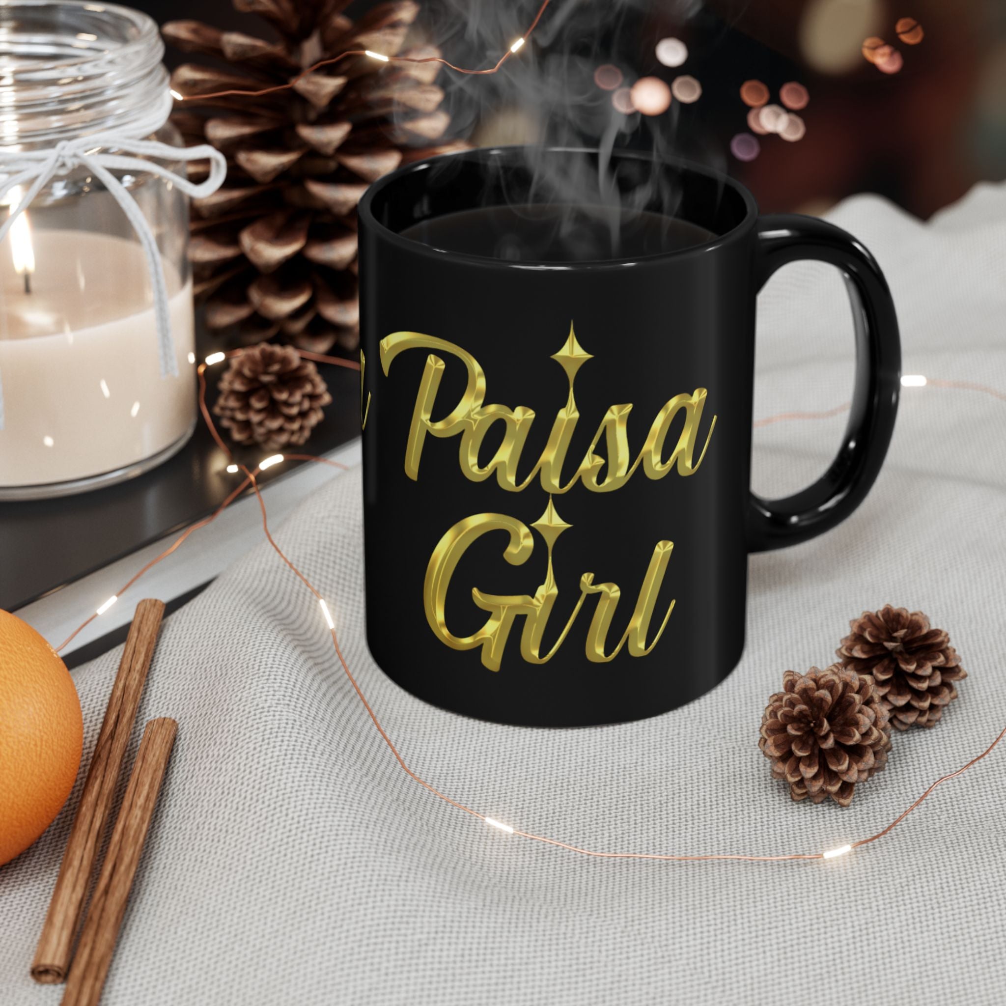 Young Hispanic woman smiling in a modern kitchen while holding a paisa black ceramic mug with gold Paisa Girl lettering and steam rising from hot coffee