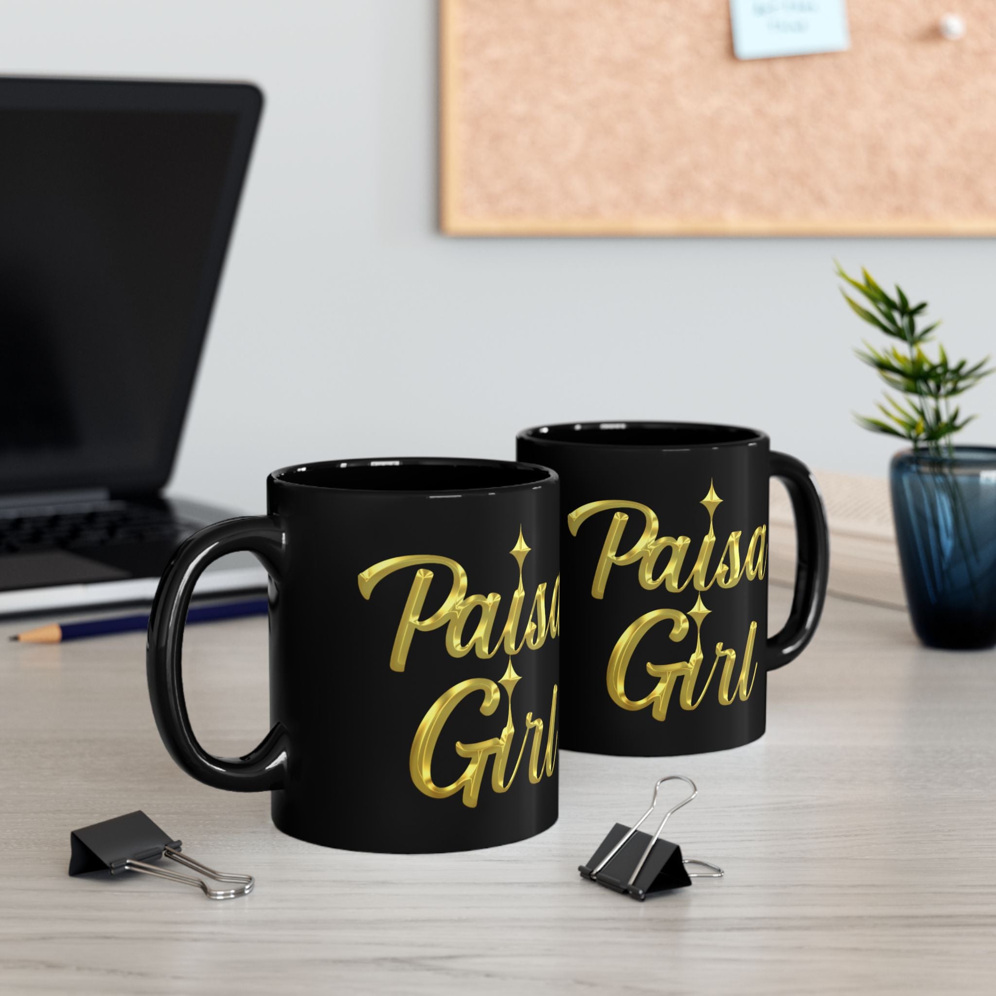 Close-up of paisa black ceramic mug featuring bold gold Paisa Girl design, glossy finish, and crisp lettering in a lifestyle setting