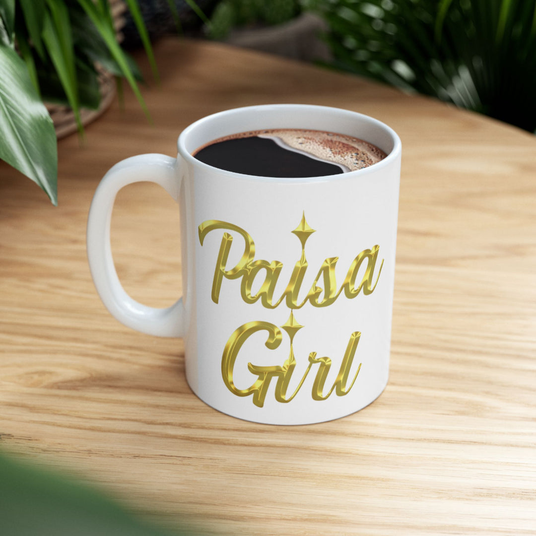 Paisa Girl Ceramic mug with gold lettering in hands, smiling warmly.