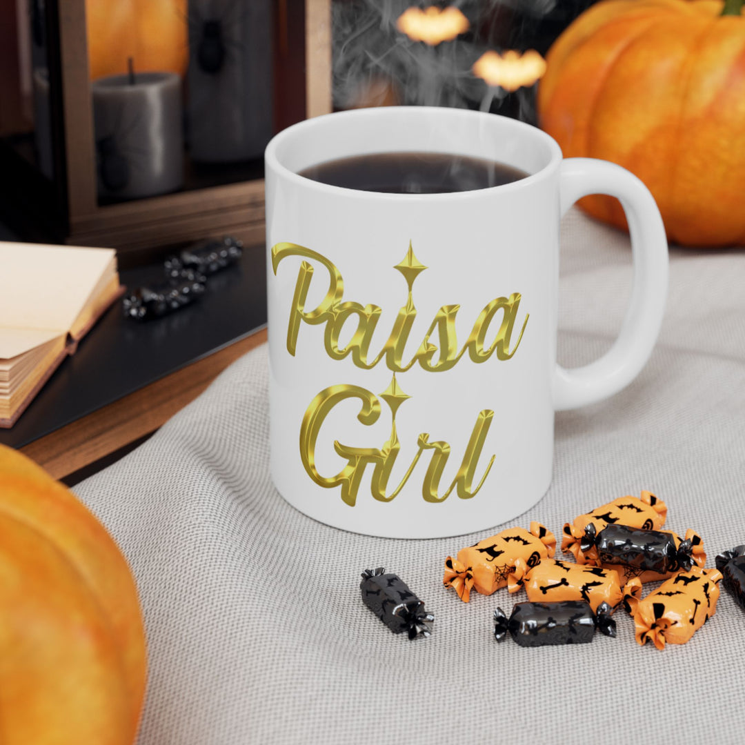 Paisa Girl Ceramic mug with gold lettering in natural daylight indoor background.